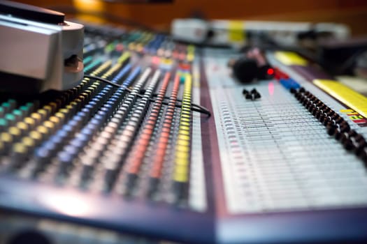 Zoomed view on sound mixer with regulation buttons