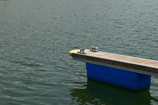 Detail of a wooden floating dock with mooring bitts