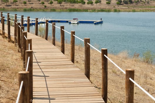 Wooden walkway serving Amieira pier on the banks of the reservoir of Alqueva, Alentejo, Portugal