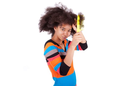 Black African American teenage girl combing her afro hair, isolated on white background