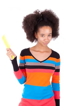 Black African American teenage girl combing her afro hair, isolated on white background