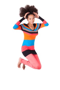 Black African American teenage girl with a afro haircut jumping of joy, isolated on white background
