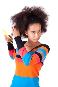Black African American teenage girl combing her afro hair, isolated on white background