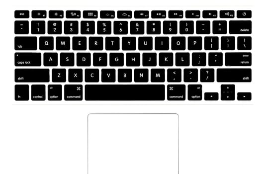 View of the modern laptop keyboard from above. English letters and metal surface, touchpad in bottom.