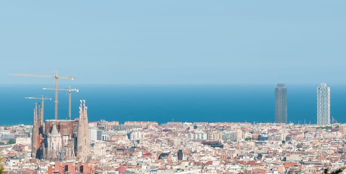 Panorama of Barcelona cityscape with Sagrada Familia  in foreground and sea in background. Barcelona, Catalonia, Spain, Europe.