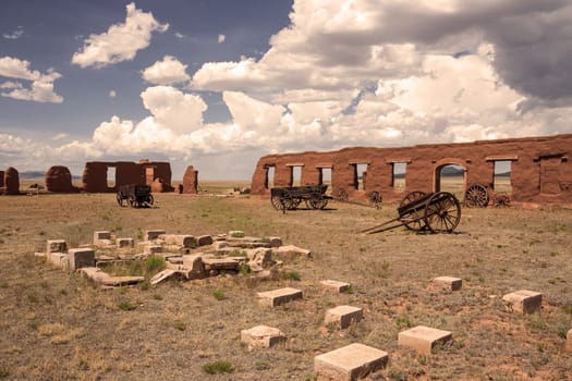 Ruins and wagons at Fort Union in sepia tone