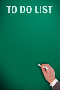 to do list on green chalkboard and an hand with chalk
