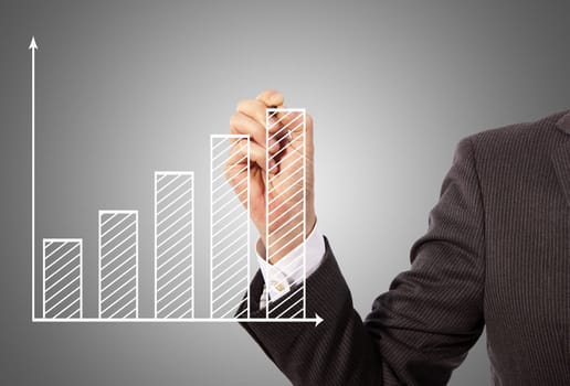 Male hand drawing a graph, grey background
