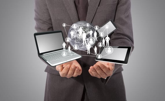 business man with technology concept in his hand, grey background