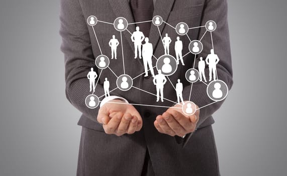 business man with technology concept in his hand, grey background