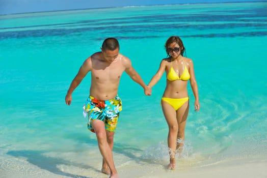 happy young asian couple have fun and romantic time at  summer on beautiful white sand beach