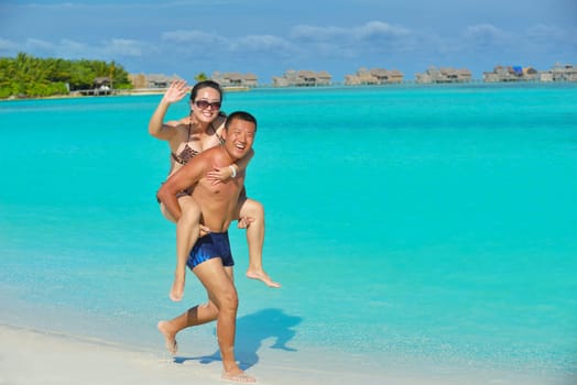 happy young asian couple have fun and romantic time at  summer on beautiful white sand beach