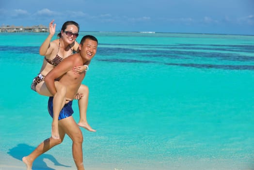 happy young asian couple have fun and romantic time at  summer on beautiful white sand beach