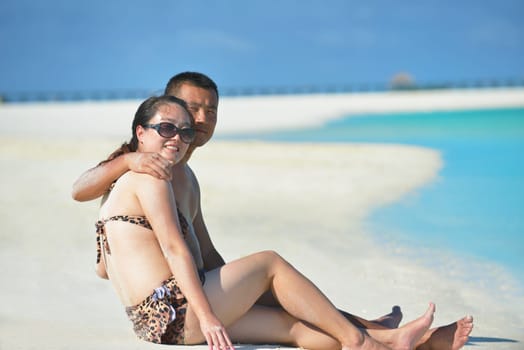 happy young asian couple have fun and romantic time at  summer on beautiful white sand beach