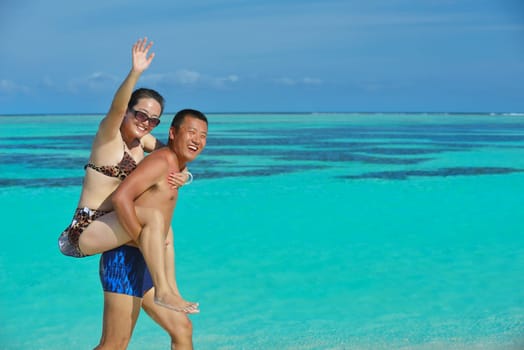 happy young asian couple have fun and romantic time at  summer on beautiful white sand beach