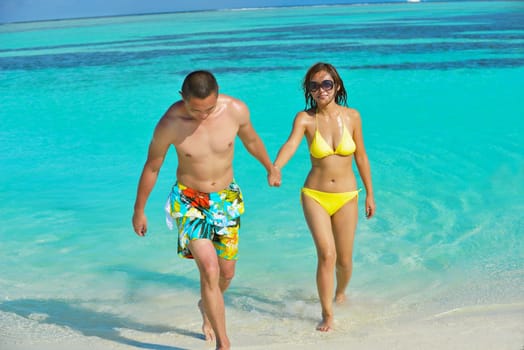 happy young asian couple have fun and romantic time at  summer on beautiful white sand beach