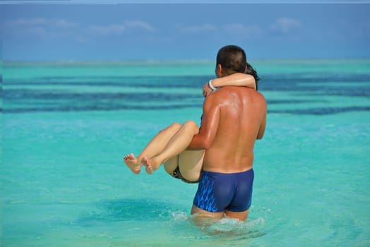 happy young asian couple have fun and romantic time at  summer on beautiful white sand beach