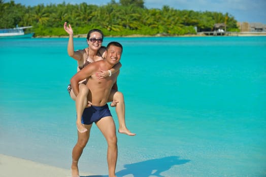 happy young asian couple have fun and romantic time at  summer on beautiful white sand beach