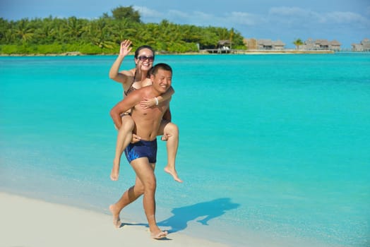 happy young asian couple have fun and romantic time at  summer on beautiful white sand beach