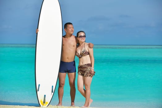 happy young asian couple have fun and romantic time at  summer on beautiful white sand beach