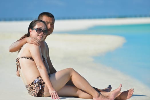 happy young asian couple have fun and romantic time at  summer on beautiful white sand beach