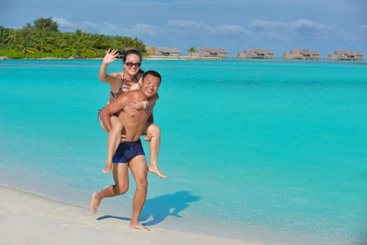happy young asian couple have fun and romantic time at  summer on beautiful white sand beach