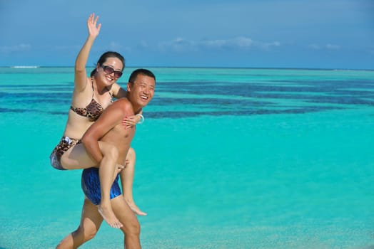 happy young asian couple have fun and romantic time at  summer on beautiful white sand beach