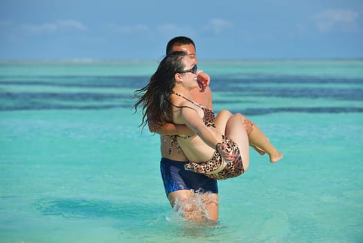 happy young asian couple have fun and romantic time at  summer on beautiful white sand beach