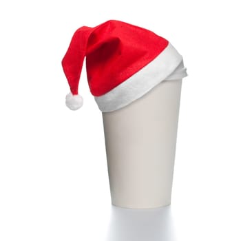 White paper coffee cup with plastic cap on top. Blank space for copy on cup and besides. Red santa christmas hat on top of the cup. Square format.