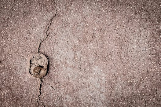 asphalt background with crack. Lots of detail, texture and copy space.