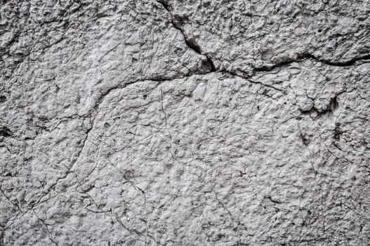 concrete wall background with cracks. Lots of detail, texture and copy space.
