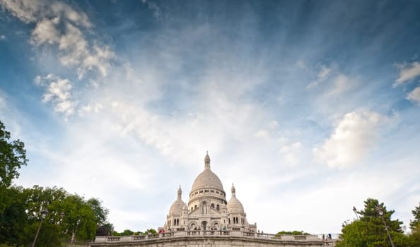 Wide view of Basilica of the Sacred Heart of Paris with blue cloudy sky (Paris, France, Europe).