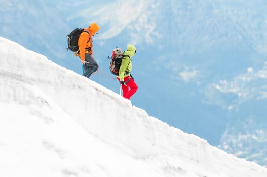 Two mountaineers on hike in snow mountains, Alps, Europe.