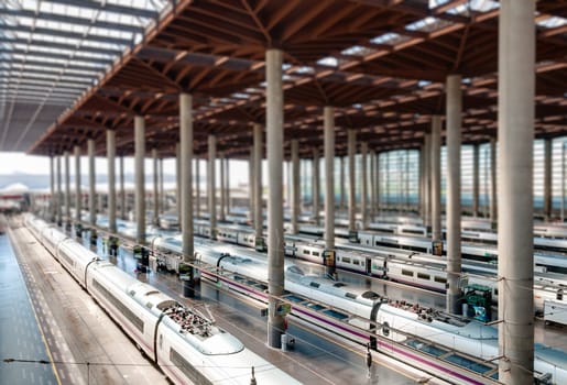 Atocha Madrid train station terminal. Modern station building with modern trains. Tilt shift effect. Madrid, Spain, Europe.