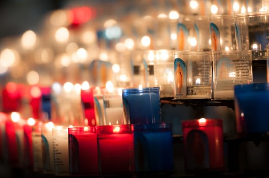 Rows of candles in catholic church in Lyon, France, Europe.