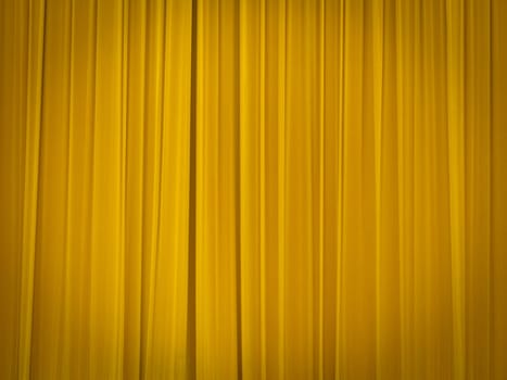 stage of the theatre with yellow curtains closed