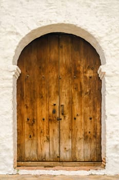 Wooden door on the side of a white colonial church