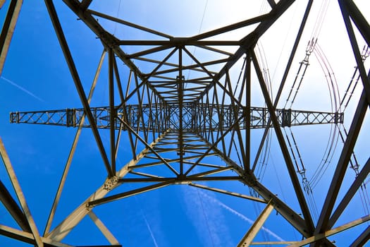 Photographed in the center of the electricity pylon in front of a deep blue sky