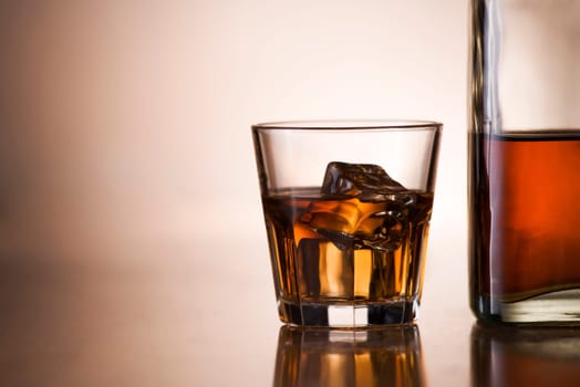 Glass of whiskey and bottle close up shoot