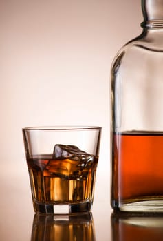 Glass of whiskey and bottle close up shoot