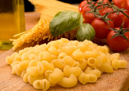 italian pasta with tomatoes basil and oil close up