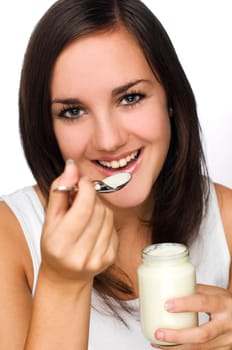 young beautiful woman eating yogurt close up