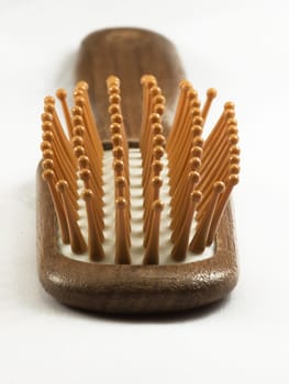 Wooden hair brush isolated on white background.