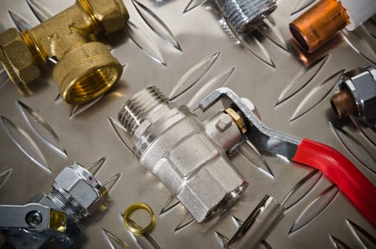 Plumbing inlet pipe valve on a metal surface