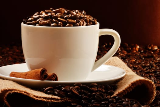 Composition with white cup and coffee beans