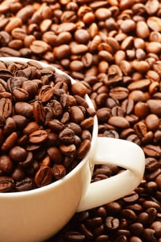 Composition with white cup and coffee beans