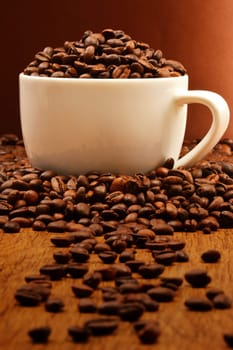 Composition with white cup and coffee beans