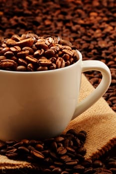 Composition with white cup and coffee beans