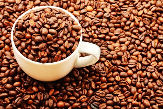 Composition with white cup and coffee beans