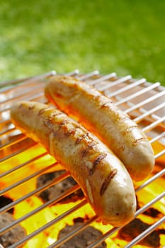 Grilled Bratwurst on the grilling pan outdoors